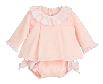 Pink baby outfit with ruffled collar and matching diaper on a white background